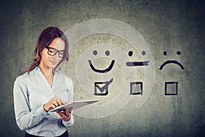 Happy business woman giving excellent rating for online satisfaction survey