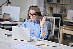 Happy business woman having online work hybrid meeting video call in office.