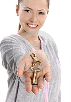 Happy business woman holding keys on white