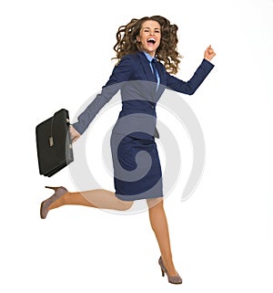 Happy business woman jumping with briefcase