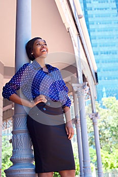 Happy business woman laughing outside office building