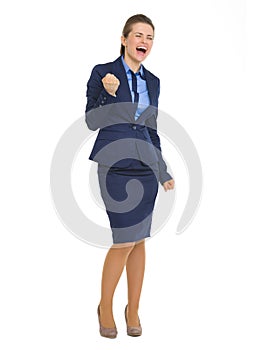 Happy business woman making fist pump gesture
