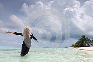 Happy business woman on the ocean coast