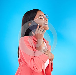 Happy business woman, phone call and laughing for funny joke, meme or conversation against a blue studio background