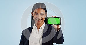 Happy business woman, phone and green screen for advertising against a blue studio background. Portrait of female person