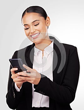 Happy business woman, phone and typing in social media, networking or communication against a studio background. Female