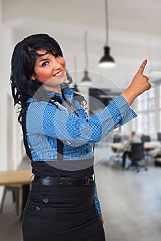 Happy business woman pointing