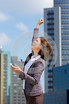 Happy business woman punching the air