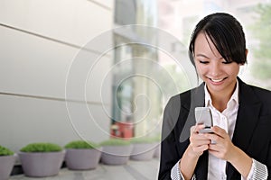 Happy business woman reading SMS