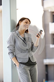 Happy business woman reading text message