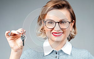 Happy business woman or real estate agent showing keys