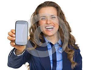 Happy business woman showing cell phone