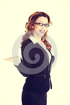 Happy business woman showing copy space