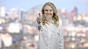 Happy business woman showing thumb up sign.