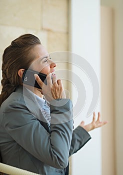 Happy business woman speaking mobile phone