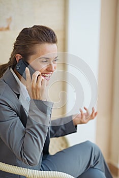 Happy business woman talking cell phone