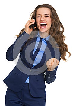 Happy business woman talking cell phone and rejoicing