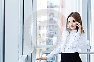 Happy business woman talking on mobile phone