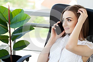 Happy business woman talking on mobile phone