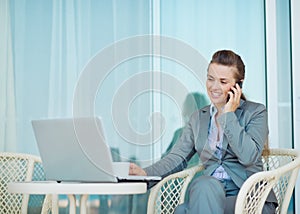 Happy business woman talking mobile phone