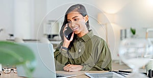 Happy business woman talking on phone call or young entrepreneur answering cellphone while sitting in front of work