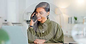 Happy business woman talking on phone call or young entrepreneur answering cellphone while sitting in front of work