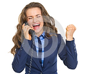 Happy business woman talking phone and rejoicing