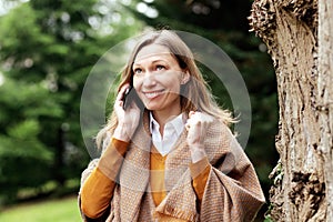 Happy business woman talking on smartphone