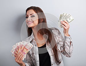 Happy business woman thinking that currency to choose, dollars o