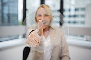 Happy Business woman thumbs up. Modern office background
