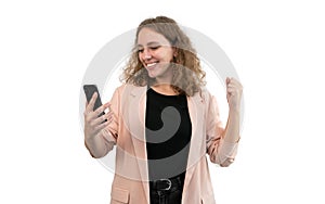 Happy business woman with winning gesture holding her phone on white background