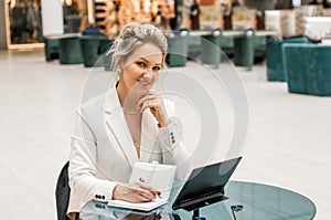 Happy business woman working in office with documents. business woman in a business suit works at the table with documents