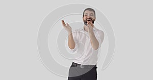 Happy businessman applauding over white