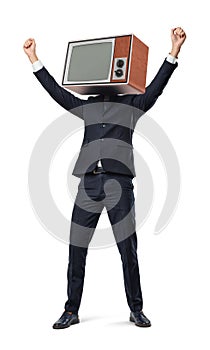 A happy businessman with arms raised in victory motion wears an old TV set instead of his head.