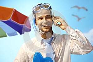 Happy businessman on the beach