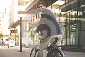 Happy businessman on a bike. Business man leaving his work. From