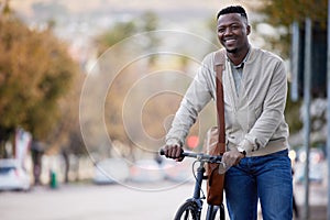 Happy, businessman and bike for eco friendly transportation and commute to work in the city. Black man, bicycle and