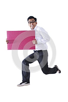 Happy businessman with a blank sign