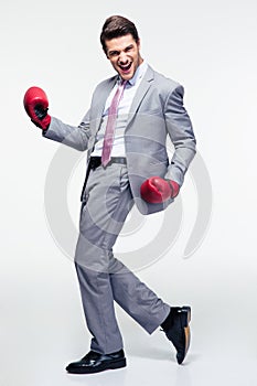 Happy businessman in boxing gloves