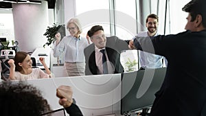 Happy businessman bumping collegues fist greeting with professional growth, success