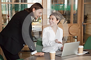 Happy businessman and businesswoman discussing good news online