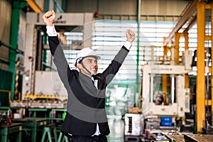 Happy businessman celebrate in factory