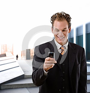 Happy businessman with cellphone