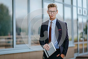 Happy businessman with digital tablet. Portrait of a Male executive manager in trendy clothes with tablet PC in hand on