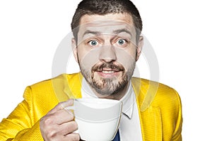 Happy businessman drinking coffee from big coup