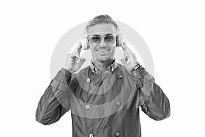 Happy businessman enjoying music in headphones, music. Smiling man listening to music in studio