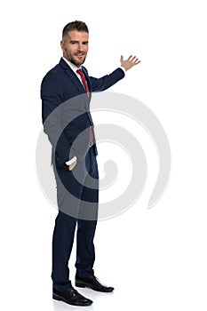 Happy businessman feeling relaxed and pointing to the side