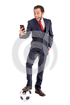 Happy businessman with football and phone