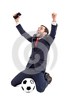 Happy businessman with football and phone