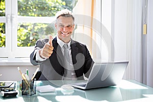 Happy Businessman Gesturing Thumbs Up